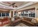 Inviting living room with lake views, comfortable seating, and coffered ceiling at 13635 Legends Walk Ter, Lakewood Ranch, FL 34202