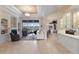 Open-concept living room with tile flooring, fireplace, and views of the pool area at 13635 Legends Walk Ter, Lakewood Ranch, FL 34202