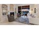 Comfortable living room with fireplace and sliding glass doors to the pool area at 13635 Legends Walk Ter, Lakewood Ranch, FL 34202