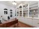 Home office boasts custom built-in shelving and a classic wood desk at 13635 Legends Walk Ter, Lakewood Ranch, FL 34202