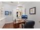 Cozy home office features a dark wood desk, built-in shelves, and arched doorways at 13635 Legends Walk Ter, Lakewood Ranch, FL 34202