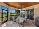 Covered patio with ceiling fan, outdoor television and golf course views at 13635 Legends Walk Ter, Lakewood Ranch, FL 34202