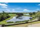 Scenic view of a pond with a fountain on a lush golf course at 13635 Legends Walk Ter, Lakewood Ranch, FL 34202