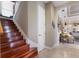 Beautiful staircase with hardwood steps and a view into the living area at 13635 Legends Walk Ter, Lakewood Ranch, FL 34202