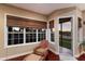 Relaxing sun room with comfortable chair and outdoor view at 13635 Legends Walk Ter, Lakewood Ranch, FL 34202