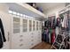 Walk-in closet with abundant storage, white cabinetry, and glass block window at 13635 Legends Walk Ter, Lakewood Ranch, FL 34202
