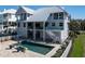 Stunning elevated coastal home with a private pool, well-manicured backyard, and white picket fence at 137 Big Pass Ln, Sarasota, FL 34242
