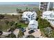 Breathtaking aerial view of coastal home with lush landscaping, garage and beach access at 137 Big Pass Ln, Sarasota, FL 34242