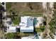 An aerial view of a home with a pool, outdoor lounge area, and manicured lawn at 137 Big Pass Ln, Sarasota, FL 34242