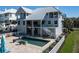 Picture of an elevated coastal home with a private pool, well-manicured backyard, and white picket fence at 137 Big Pass Ln, Sarasota, FL 34242