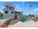 Stunning backyard showcasing the inviting pool, attractive house elevation, and pristine landscaping at 137 Big Pass Ln, Sarasota, FL 34242