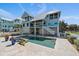 Impressive backyard featuring a pool, hot tub, and manicured landscaping at 137 Big Pass Ln, Sarasota, FL 34242