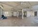 Spacious open basement with concrete ceilings, travertine flooring, and columns at 137 Big Pass Ln, Sarasota, FL 34242