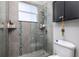 Modern bathroom with tiled walk-in shower, rainfall showerhead, built-in shelves, and neutral colors at 137 Big Pass Ln, Sarasota, FL 34242
