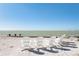 A serene beachfront view with four Adirondack chairs for relaxing by the ocean at 137 Big Pass Ln, Sarasota, FL 34242