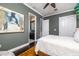Bedroom featuring a king bed, an ensuite bathroom, closet and a large art piece on the wall at 137 Big Pass Ln, Sarasota, FL 34242