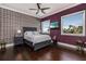 This modern bedroom has hardwood floors, a ceiling fan, and large windows with a view of the beach at 137 Big Pass Ln, Sarasota, FL 34242