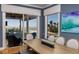 Elegant dining room with water views, wood table, and access to an outdoor seating area at 137 Big Pass Ln, Sarasota, FL 34242
