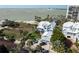 Stunning coastal home with a metal roof, manicured landscaping, and beach views at 137 Big Pass Ln, Sarasota, FL 34242