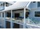 Beautiful coastal home featuring a covered patio with glass railing and a peek of the outdoor space at 137 Big Pass Ln, Sarasota, FL 34242