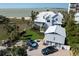Breathtaking aerial view of coastal home with lush landscaping, garage and beach access at 137 Big Pass Ln, Sarasota, FL 34242