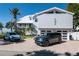Beautiful exterior shot of home and garage, showcasing curb appeal and brick driveway at 137 Big Pass Ln, Sarasota, FL 34242