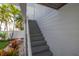 Exterior staircase leading to the entrance of the house, surrounded by lush landscaping at 137 Big Pass Ln, Sarasota, FL 34242