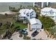 A coastal home with a metal roof, complemented by lush landscaping and a paved driveway at 137 Big Pass Ln, Sarasota, FL 34242
