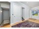 Bright foyer with hardwood floors, staircase access, and contemporary artwork at 137 Big Pass Ln, Sarasota, FL 34242