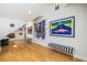 Bright hallway with hardwood floors, contemporary art, and stylish seating at 137 Big Pass Ln, Sarasota, FL 34242