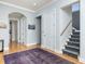 Hallway with hardwood floors, staircase, and multiple doorways leading to other rooms at 137 Big Pass Ln, Sarasota, FL 34242