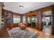 Executive home office with custom wood trim, built-in bookcase, and water views at 137 Big Pass Ln, Sarasota, FL 34242