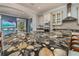 Kitchen island with stainless faucet and luxurious and unique stone countertops at 137 Big Pass Ln, Sarasota, FL 34242