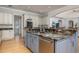 Island sink with stainless steel dishwasher and luxurious stone countertops at 137 Big Pass Ln, Sarasota, FL 34242