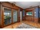 Bright living room with wood floors, custom trim and built-in entertainment center, with access to patio and views at 137 Big Pass Ln, Sarasota, FL 34242