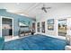 Inviting living room with bright blue accent wall and double doors to the exterior at 137 Big Pass Ln, Sarasota, FL 34242