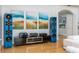 Open living room with large blue speakers, media center, and modern white sofas at 137 Big Pass Ln, Sarasota, FL 34242