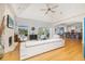 Bright and open living room featuring hardwood floors, a stone fireplace, and large windows with views of the outside at 137 Big Pass Ln, Sarasota, FL 34242