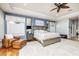 Main bedroom with wood floors, ceiling fan, plenty of space, and a comfortable seating area with ottoman at 137 Big Pass Ln, Sarasota, FL 34242
