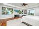 Spacious main bedroom with wood floors, recessed lighting, ceiling fan, and ample wall art at 137 Big Pass Ln, Sarasota, FL 34242