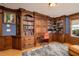 Spacious office featuring custom wood built-ins, including bookcases and desk area, with natural light and neutral rug at 137 Big Pass Ln, Sarasota, FL 34242