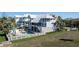 Backyard view of a luxurious pool area with lounge chairs and privacy fence at 137 Big Pass Ln, Sarasota, FL 34242