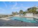 Inviting outdoor pool with sun loungers, privacy fence, and tiled surround, offering a perfect space for relaxation and enjoyment at 137 Big Pass Ln, Sarasota, FL 34242