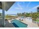 Backyard pool with direct beach access, a patio for sunbathing, and a privacy fence for a luxurious outdoor living experience at 137 Big Pass Ln, Sarasota, FL 34242