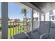 Charming porch offering picturesque views of the lawn, landscape, and neighborhood at 137 Big Pass Ln, Sarasota, FL 34242