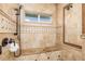 Luxurious walk-in shower with marble tile, a built-in bench, and premium fixtures at 137 Big Pass Ln, Sarasota, FL 34242