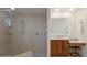 Bright bathroom showcasing a glass shower, vanity with wood cabinets, and a wall mirror at 13809 Milan Ter, Lakewood Ranch, FL 34202