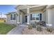 Inviting front porch with blue door, decorative planters, and a cozy bench for relaxing at 13904 Gettis Lee Rd, Parrish, FL 34219