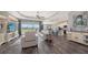 Open-concept living room boasts a leather sofa, hardwood floors, and backyard view at 13904 Gettis Lee Rd, Parrish, FL 34219