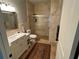 Modern bathroom with tiled shower, marble vanity, and neutral finishes at 1534 25Th St, Sarasota, FL 34234
